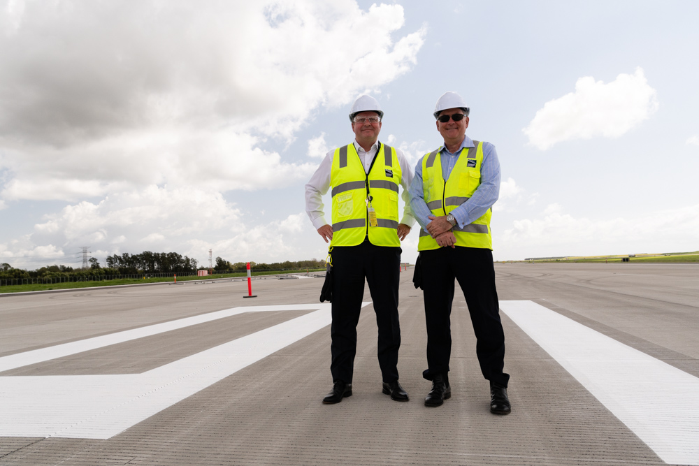 Gert-Jan de Graaff and Paul Coughlan stand before the newly painted 01L Runway