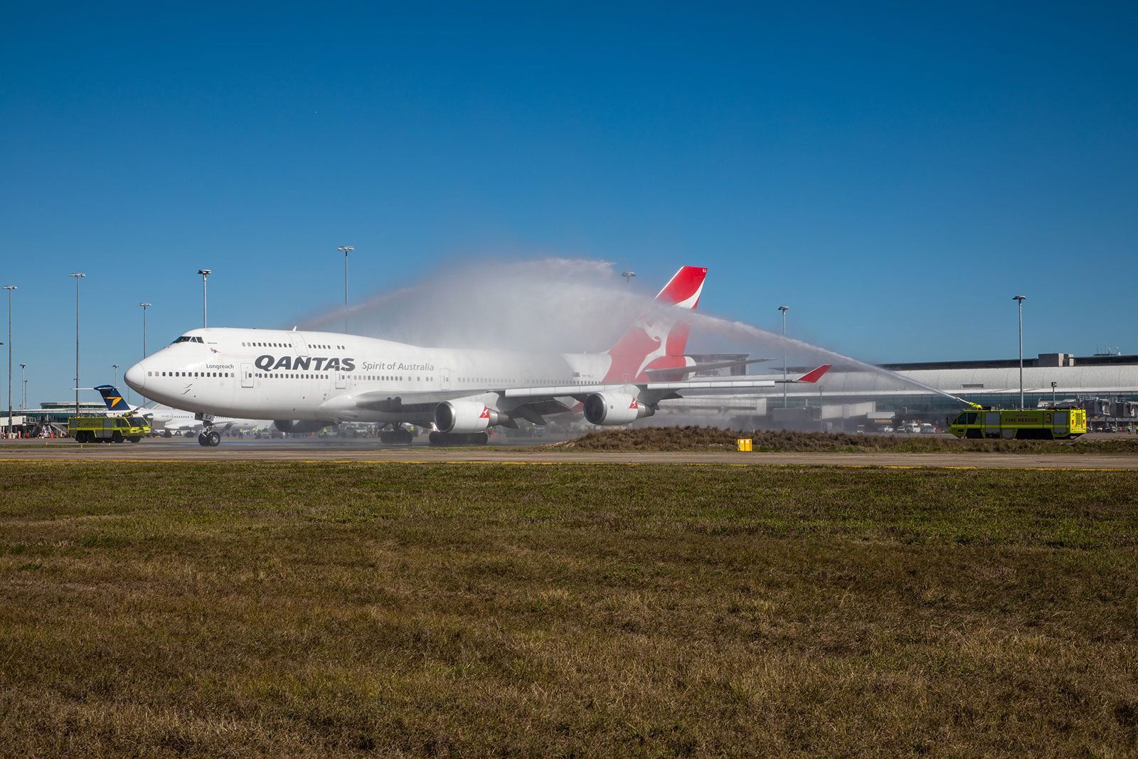 ARFF give VH-OEJ a water cannon salute before her final voyage at BNE 