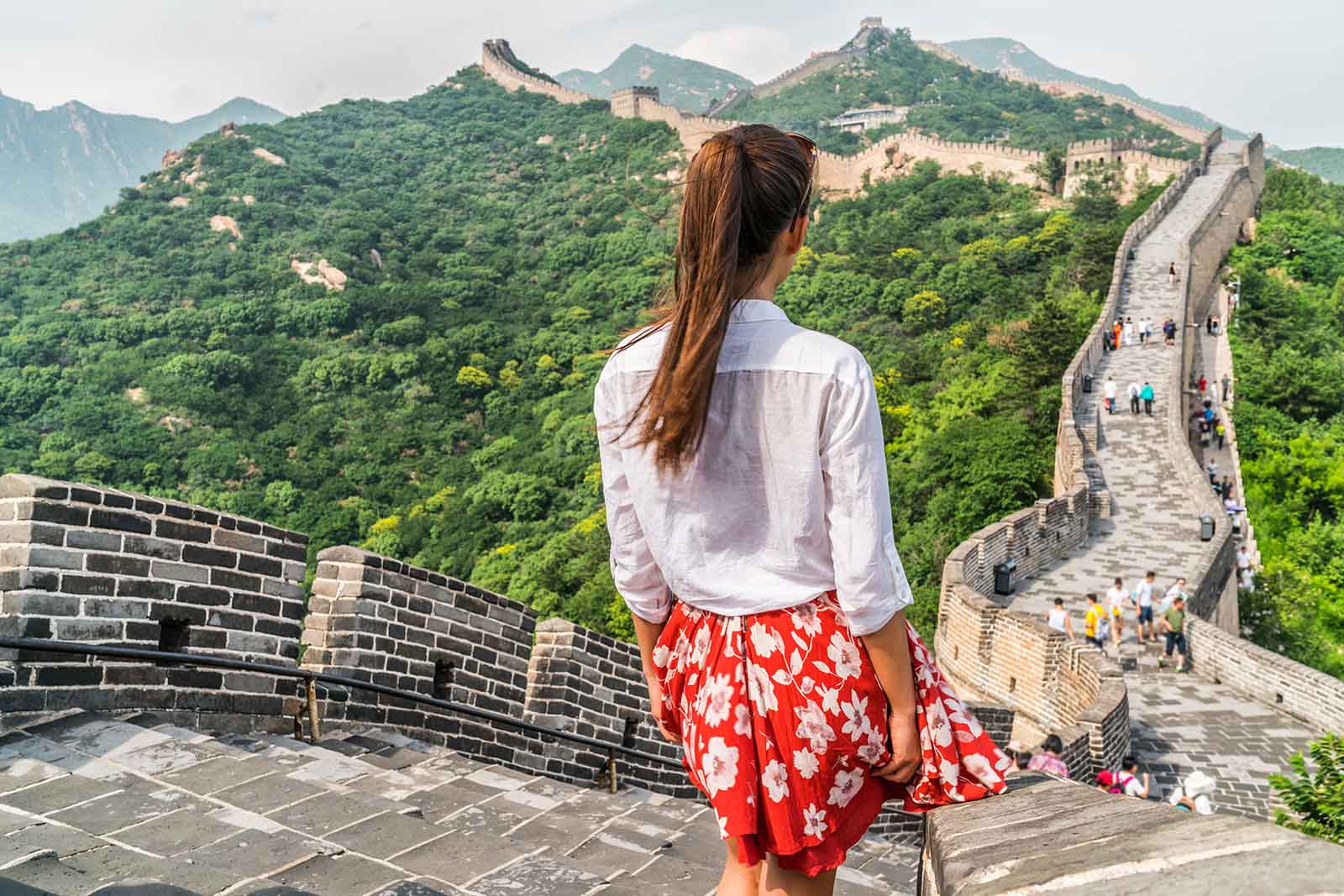 Use the cloud to store your images - girl traveller on the Great Wall of China | BNE Traveller Tips: what to do with your holiday photographs