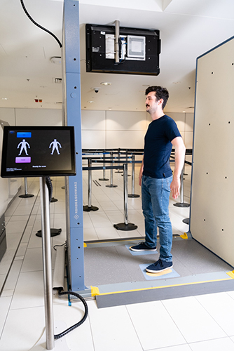 Person using body scanner at Brisbane Airport