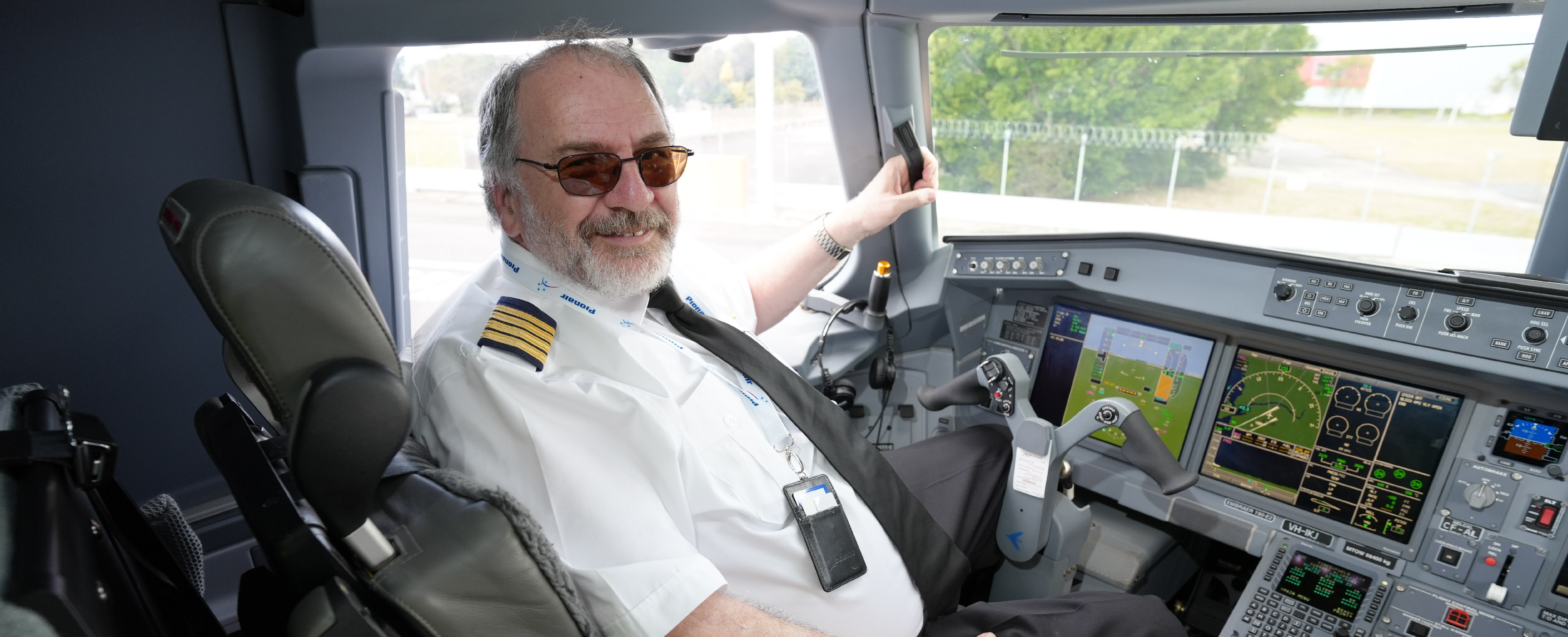 pilot sits in plane cockpit