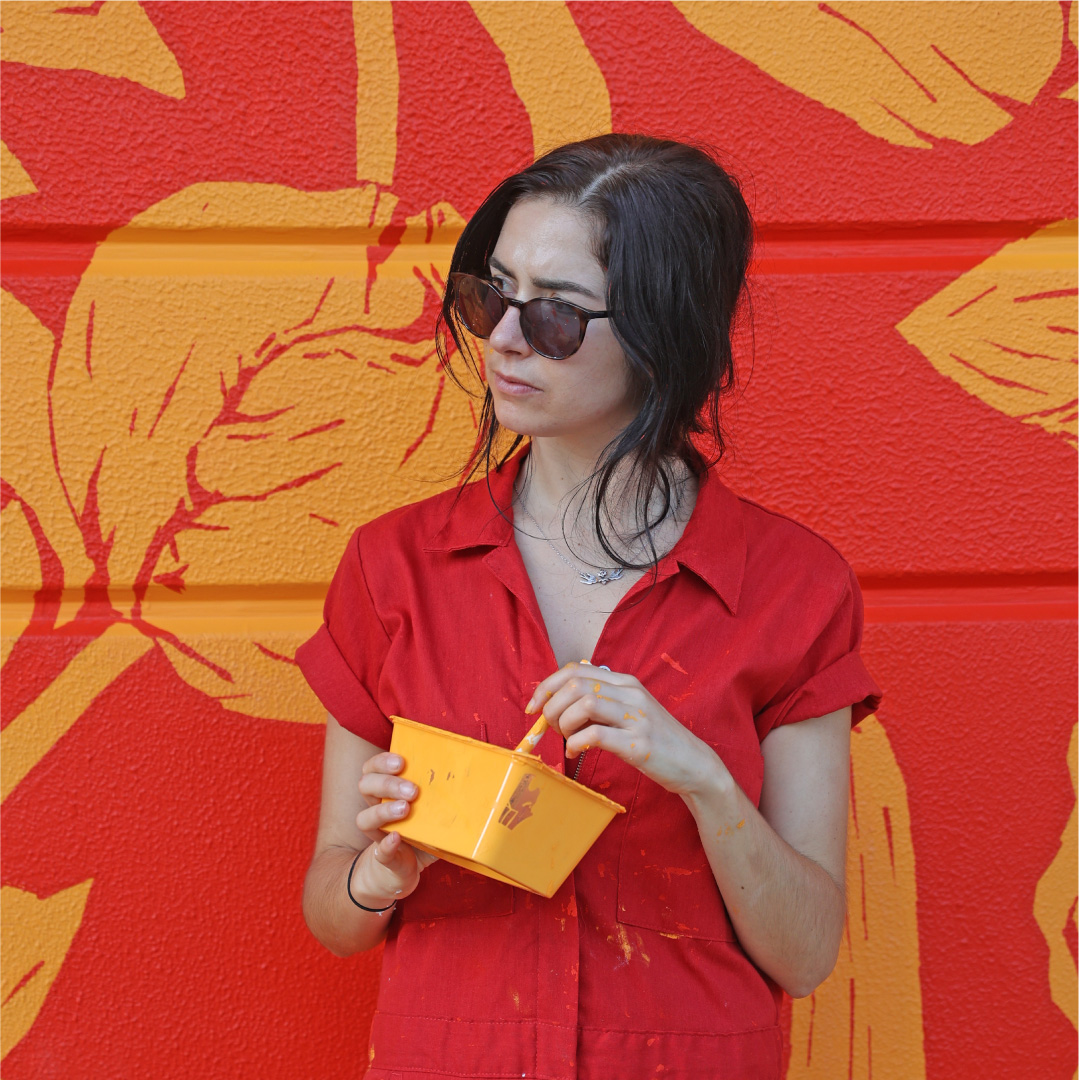 Aurora Campbell posing in front of mural Tangerine Trip