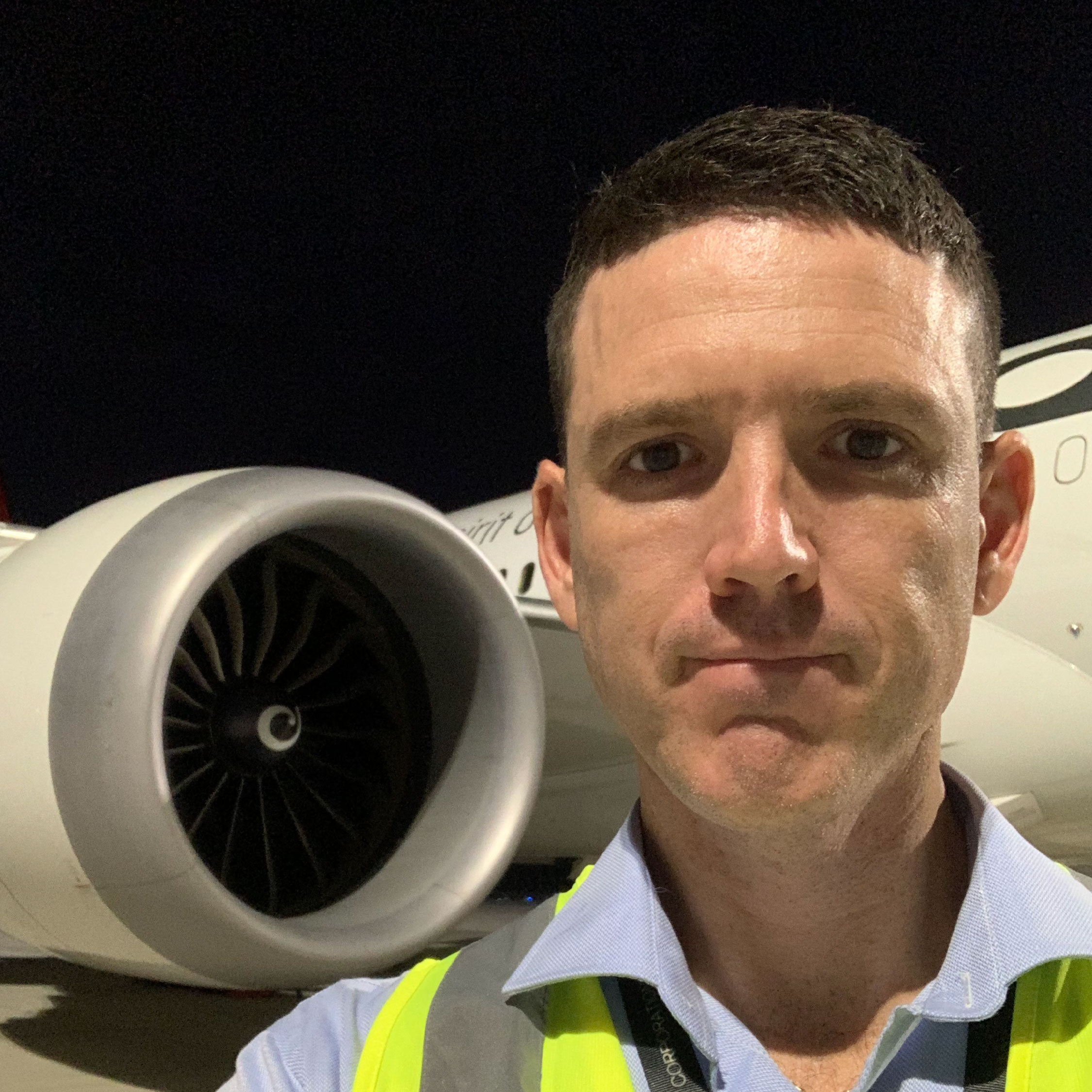 Michael Kerr in front of plane engine