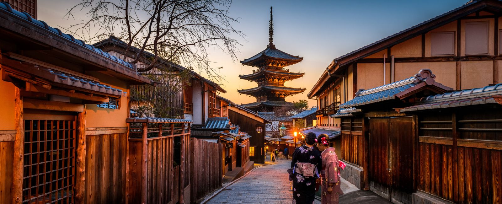 Two geishas talk in a laneway in Kyoto, Japan