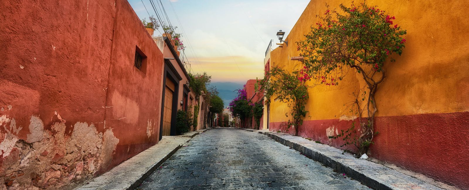 Bright orange and red buildings in a laneway in San Miguel de Allende