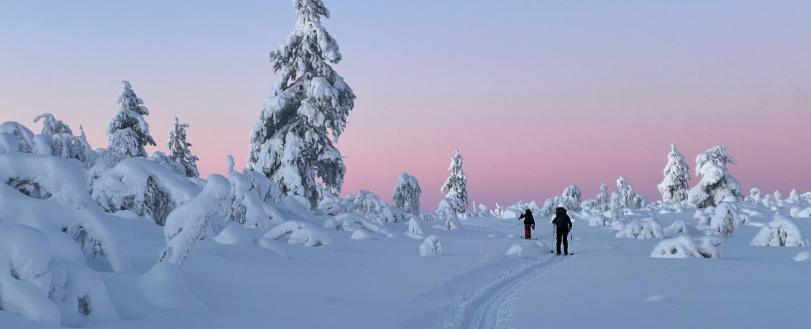 People walking in the snow in Lapland, Finland