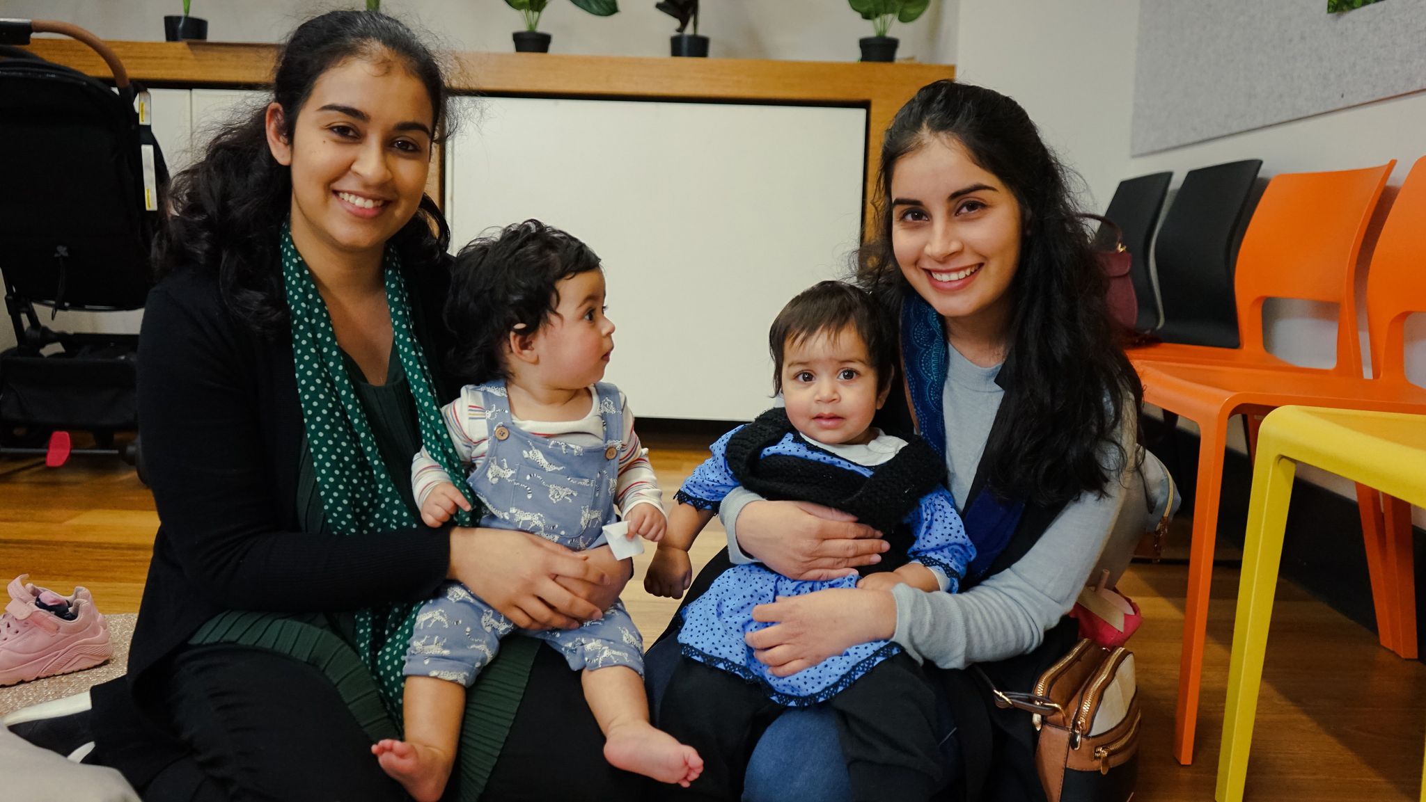 Two women holding babies