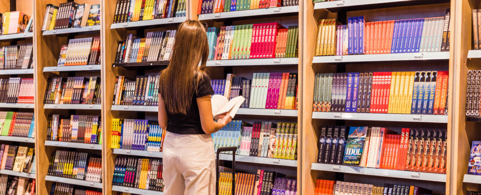 Girl standing in front of bookshelf 