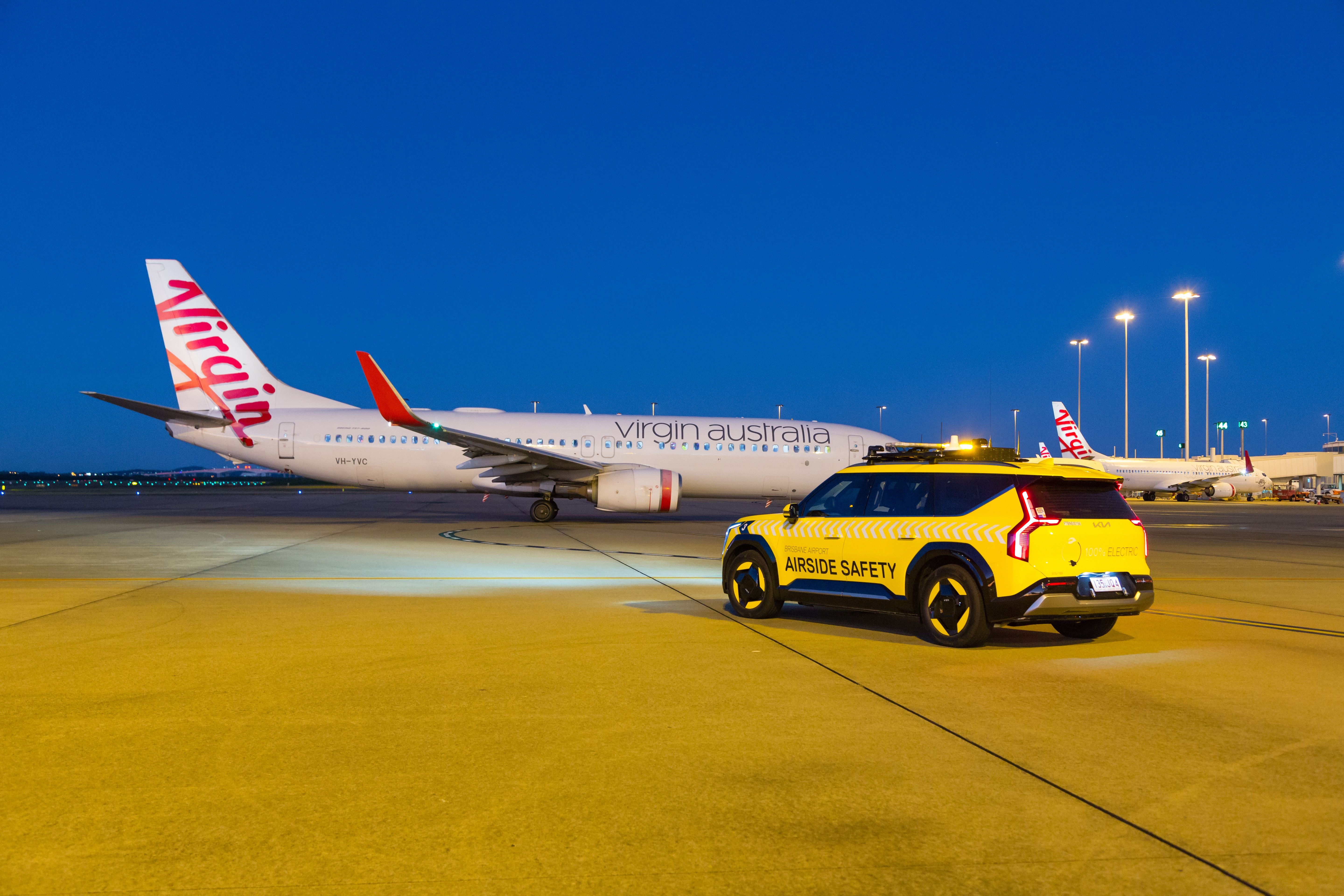 airside safety car with plane on tarmac