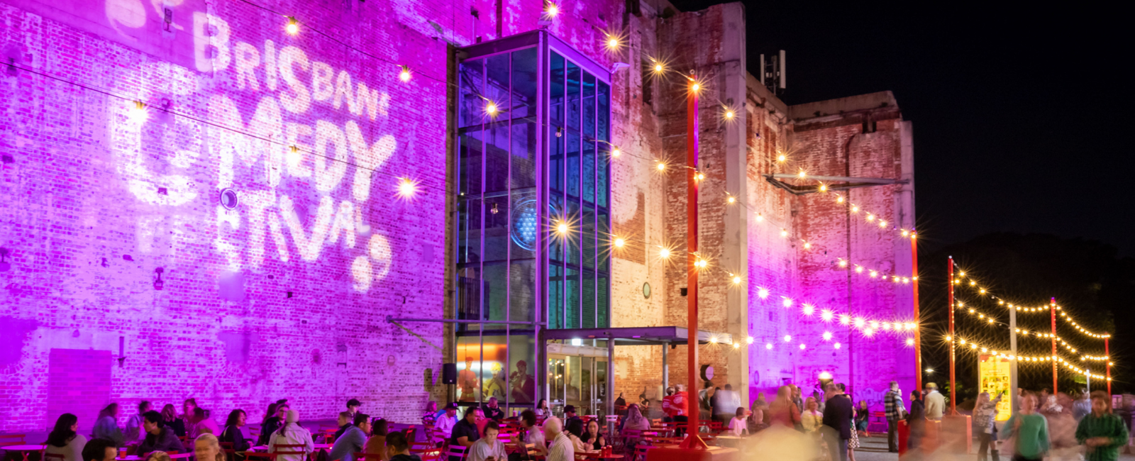 Brisbane Comedy Festival lighting on wall of Brisbane Powerhouse