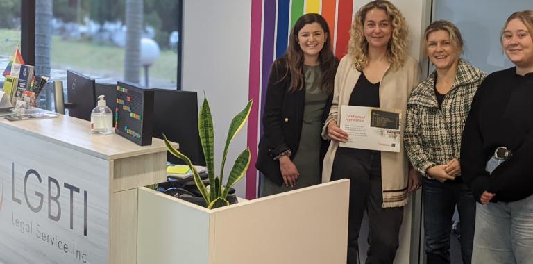 Picture of Amelia Burr with members of the LGBTI Legal Service
