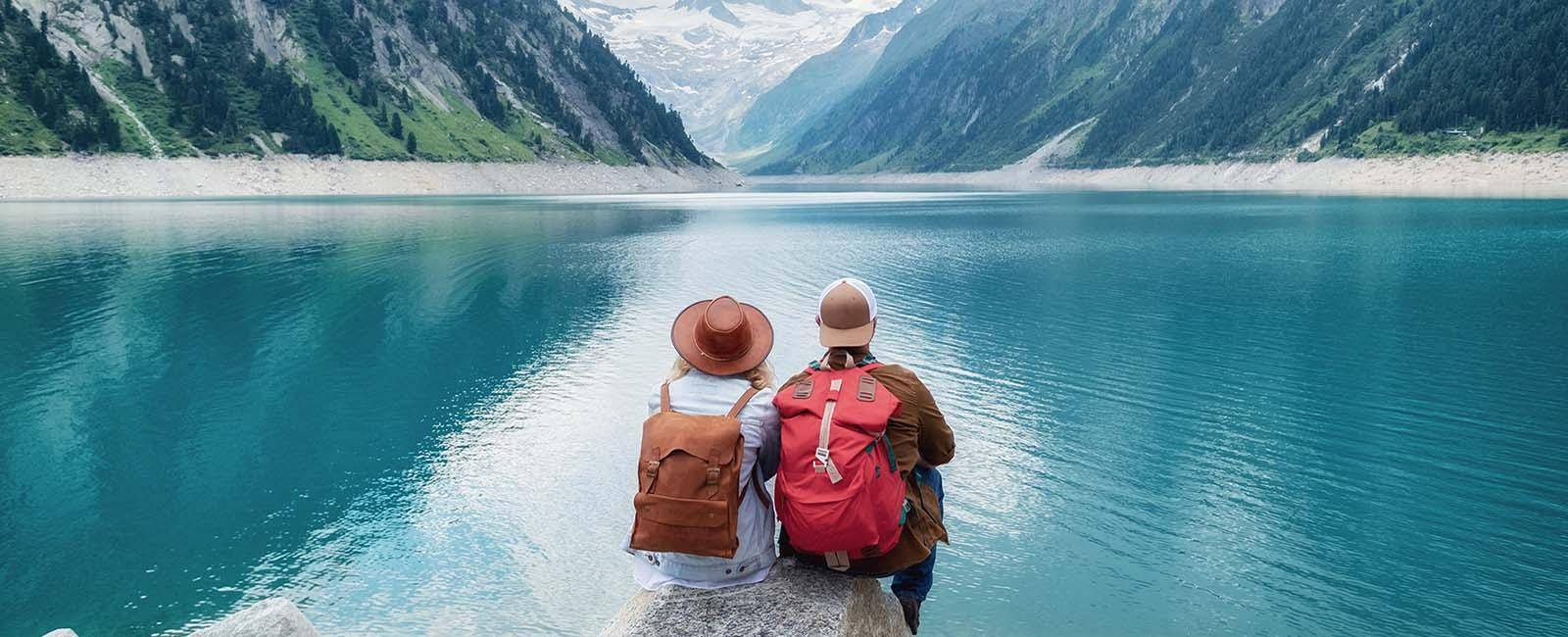 What to do with your holiday photographs - traveller couple looking out over mountain and lake | BNE Traveller Tips: What to do with your holiday photographs
