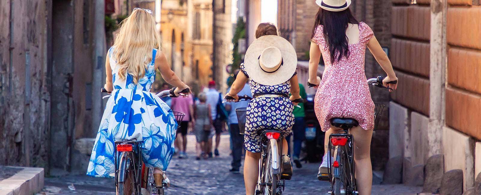 Girls riding bikes through the streets of Rome | Why slow travel is gaining momentum