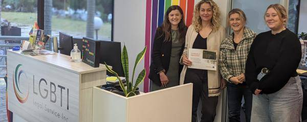 Picture of Amelia Burr with members of the LGBTI Legal Service