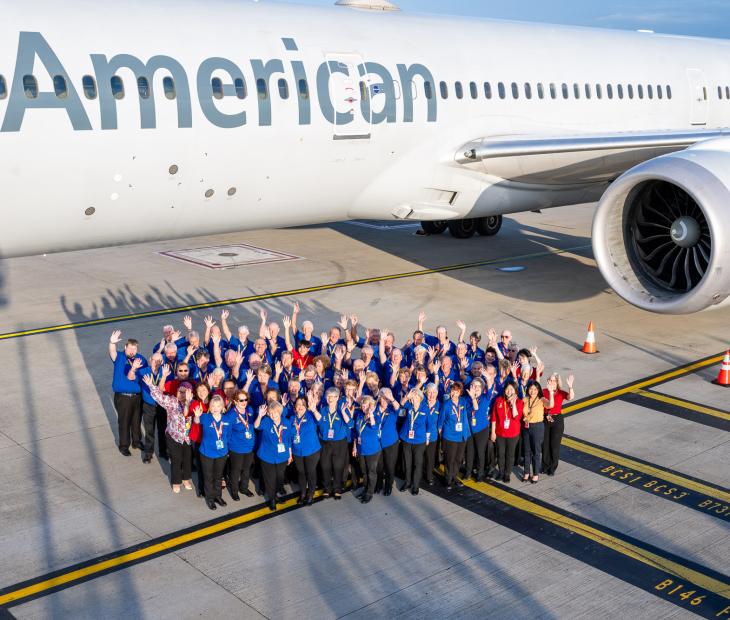 Group photo of Airport Ambassadors infront of American Airlines plane Group photo of Airport Ambassadors infront of American Airlines plane