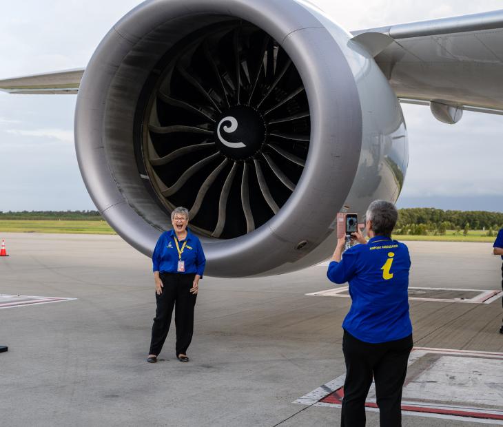 ambassadors taking photos in front of a plane ambassadors taking photos in front of a plane