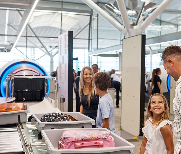 Family undergoing passenger screening at International Terminal
