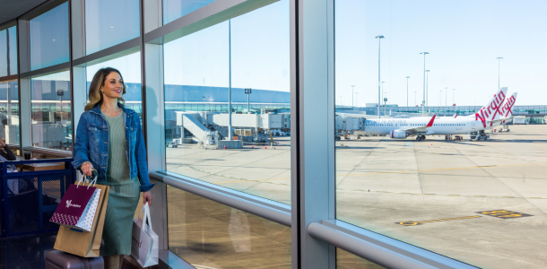 Person with shopping bags looking at runway